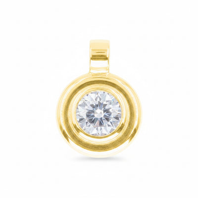 A gold pendant featuring a round clear gemstone surrounded by a double-ring gold setting, isolated on a white background.