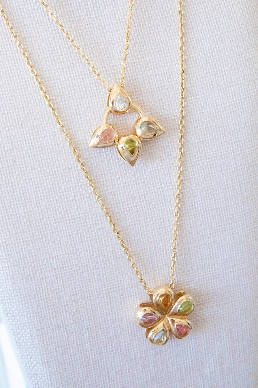Our Flower Multi Cabochon glider to put on a necklace or collar.  14K yellow gold with peridot, citrine, pink tourmaline, blue topaz, all made locally in Palm Beach Florida by jewelry design team Pelimingo Palm Beach...also pictured are Pelimingo petals in different colored cabochons.