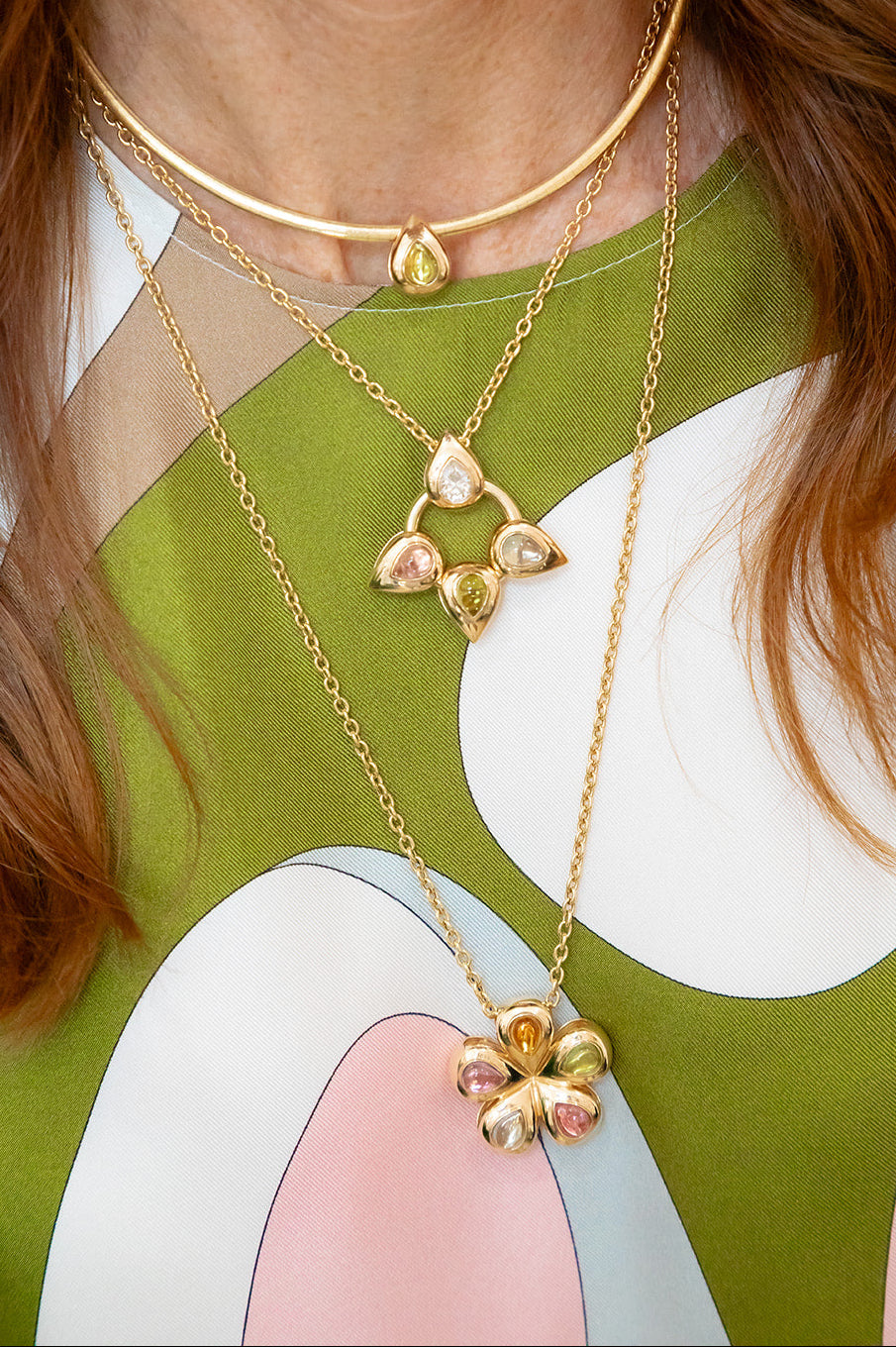 Our Flower Multi Cabochon glider to put on a necklace or collar.  14K yellow gold with peridot, citrine, pink tourmaline, blue topaz, all made locally in Palm Beach Florida by jewelry design team Pelimingo Palm Beach in pucci top with petals in cabochons too