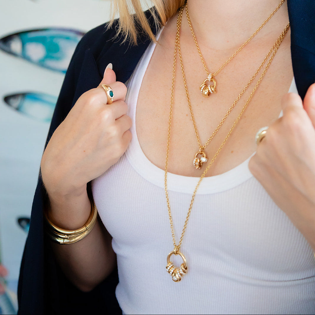 14K yellow gold petal / tear drop shape diamond drop in bezel setting.  Designed by jewelry makers in Palm Beach, Florida Pelimingo.  Local owned.  fine jewelry. women owned business