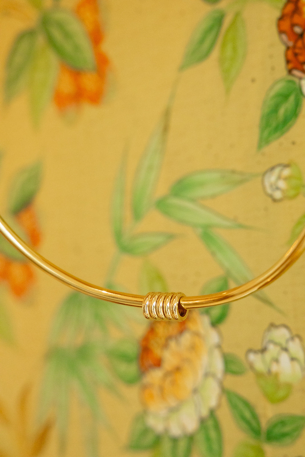 A close-up of a 14K solid gold spacers on a color or necklace.  Made locally in Palm Beach.  Palm Beach based Jewelry Designers Pelimingo