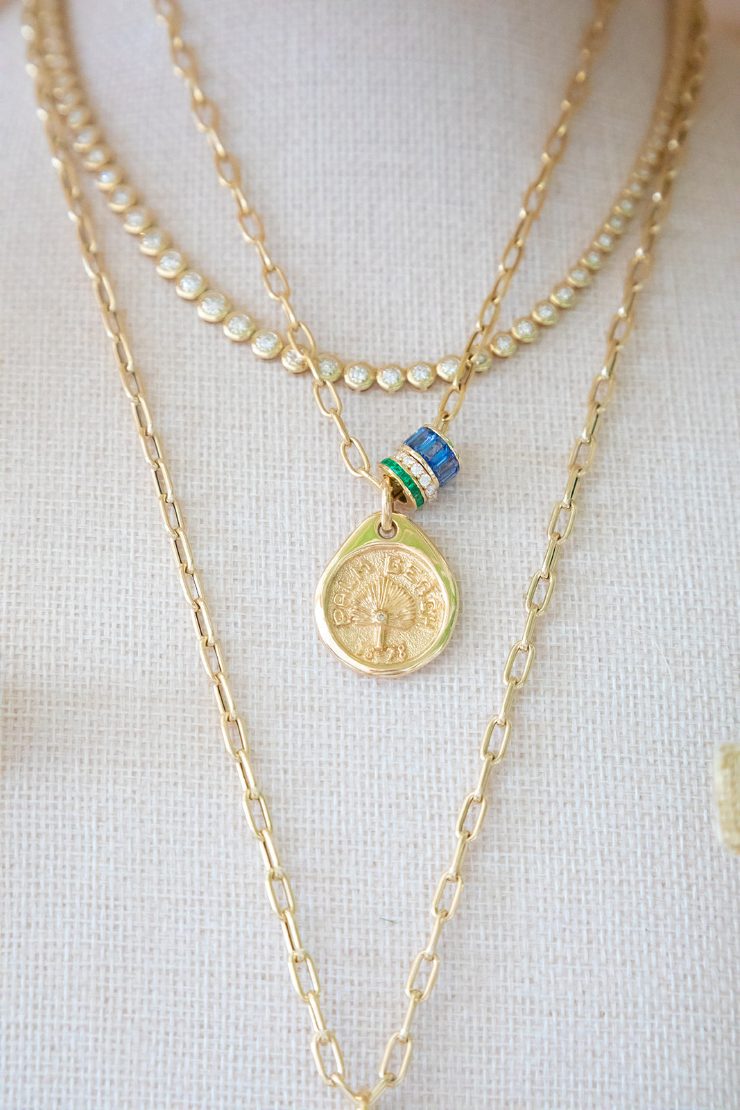 Our Palm Beach Pendant / Charm is made in 14K solid yellow gold with a satin and polished finish. Handcrafted in Palm Beach Florida by jewelry design team and local fine jewelry Pelimingo.  Palm Beach town name, date town was settled and native palm tree Sable Palm on charm.