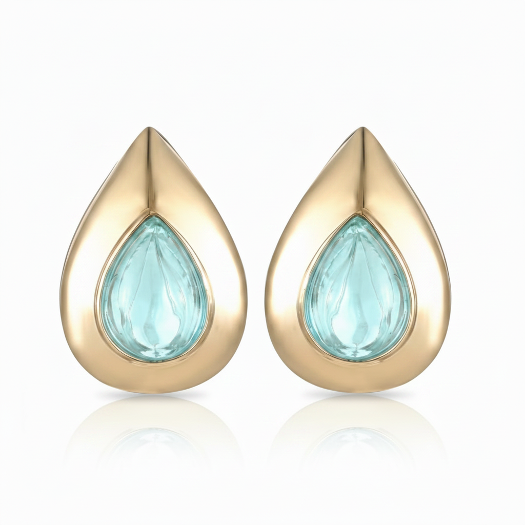 Gold teardrop-shaped petal earrings with an aquamarine gemstone set in 14K yellow gold. Designed by Palm Beach jewelry design team Pelimingo Palm Beach