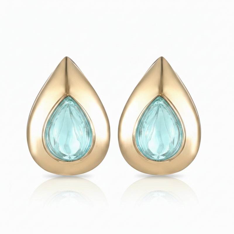 Gold teardrop-shaped petal earrings with an aquamarine gemstone set in 14K yellow gold. Designed by Palm Beach jewelry design team Pelimingo Palm Beach