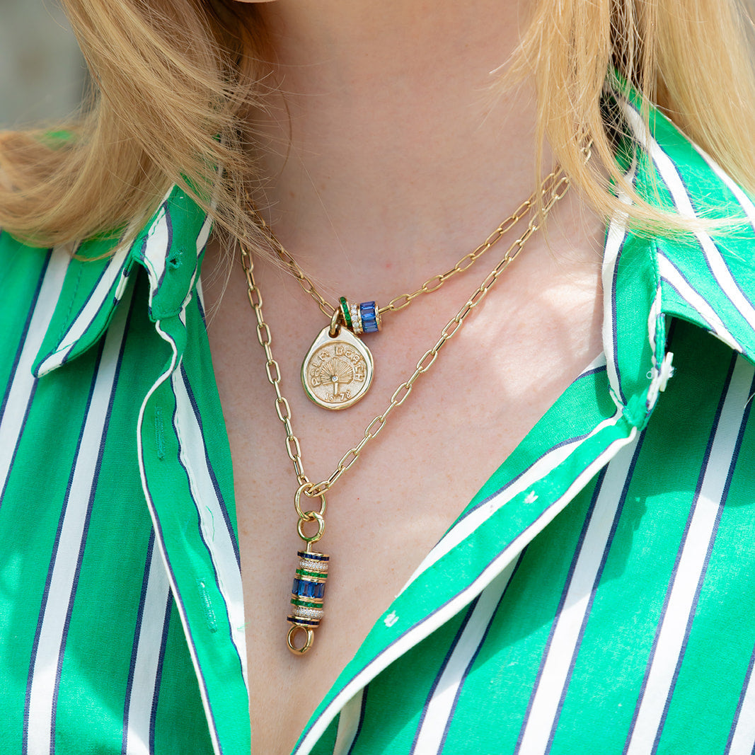 Our Palm Beach Pendant / Charm is made in 14K solid yellow gold with a satin and polished finish. Handcrafted in Palm Beach Florida by jewelry design team and local fine jewelry Pelimingo.  Palm Beach town name, date town was settled and native palm tree Sable Palm on charm.