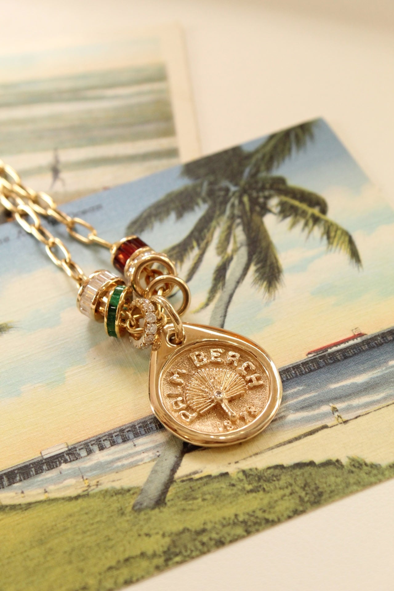 Our Palm Beach Pendant / Charm is made in 14K solid yellow gold with a satin and polished finish. Handcrafted in Palm Beach Florida by jewelry design team and local fine jewelry Pelimingo.  Palm Beach town name, date town was settled and native palm tree Sable Palm on charm.