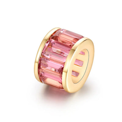 Pink gemstone charm with gold setting on a white background